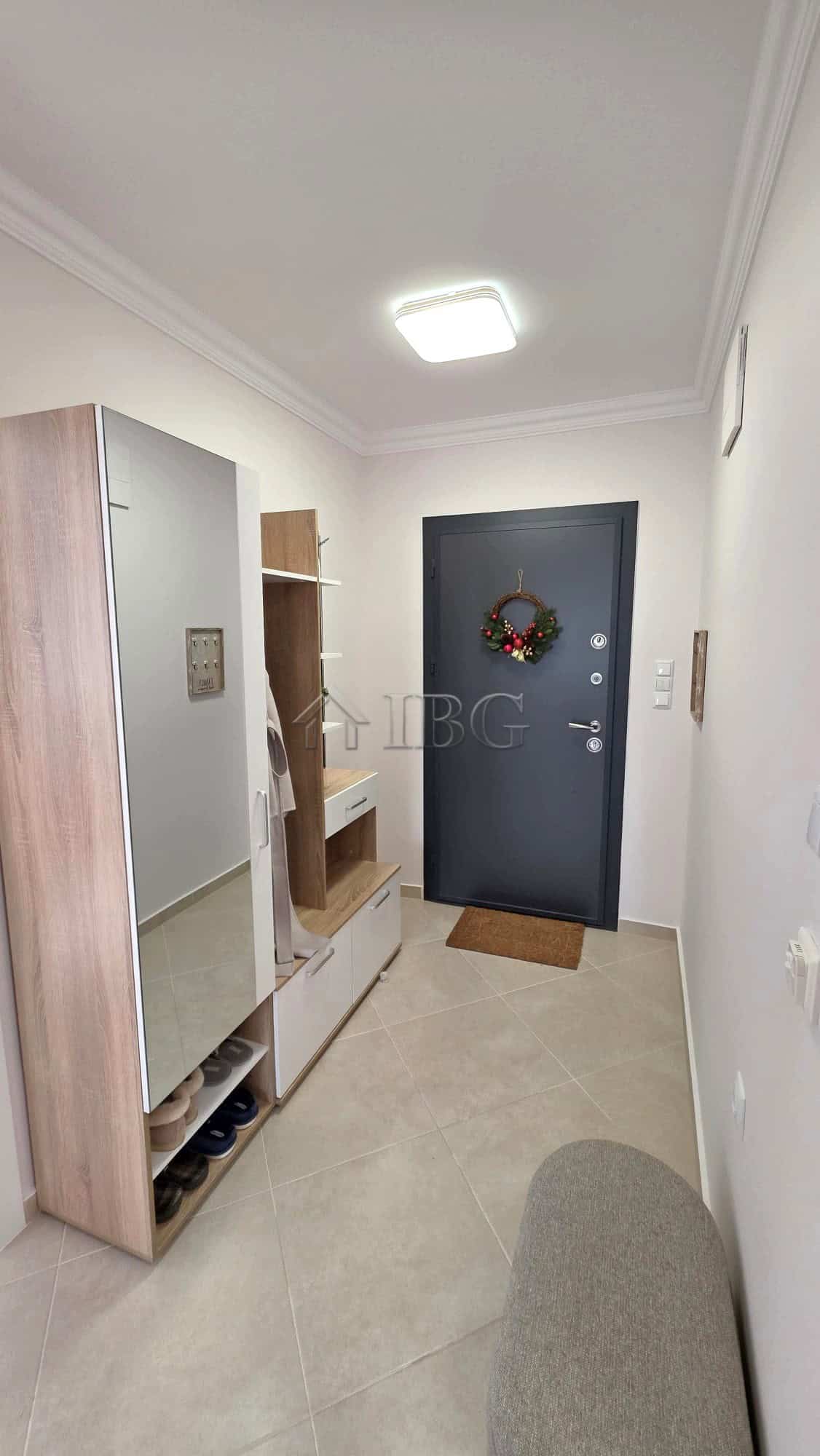 Elegant entrance hall with modern decor and a stylish door.