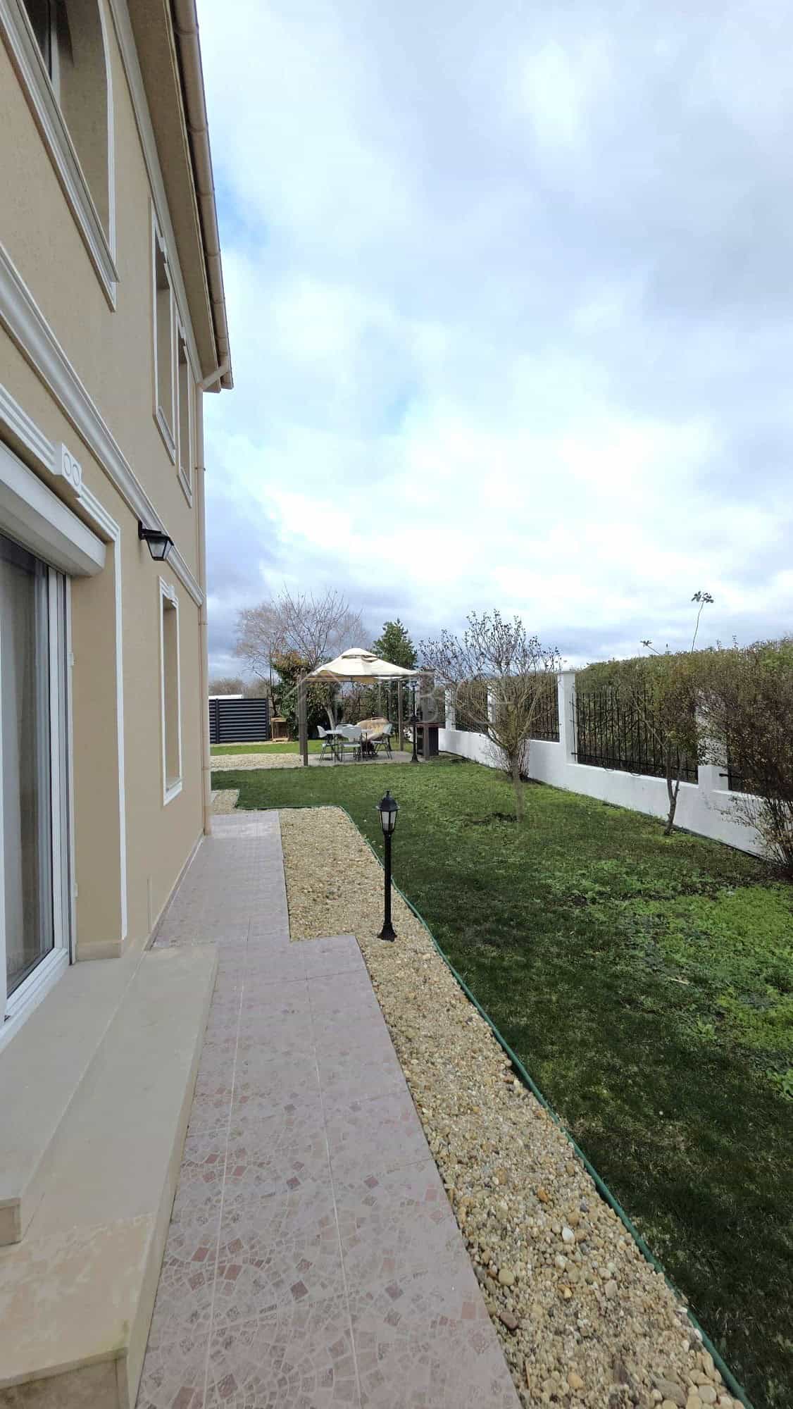 Beautiful villa exterior with a garden and pathway in Pomorie.