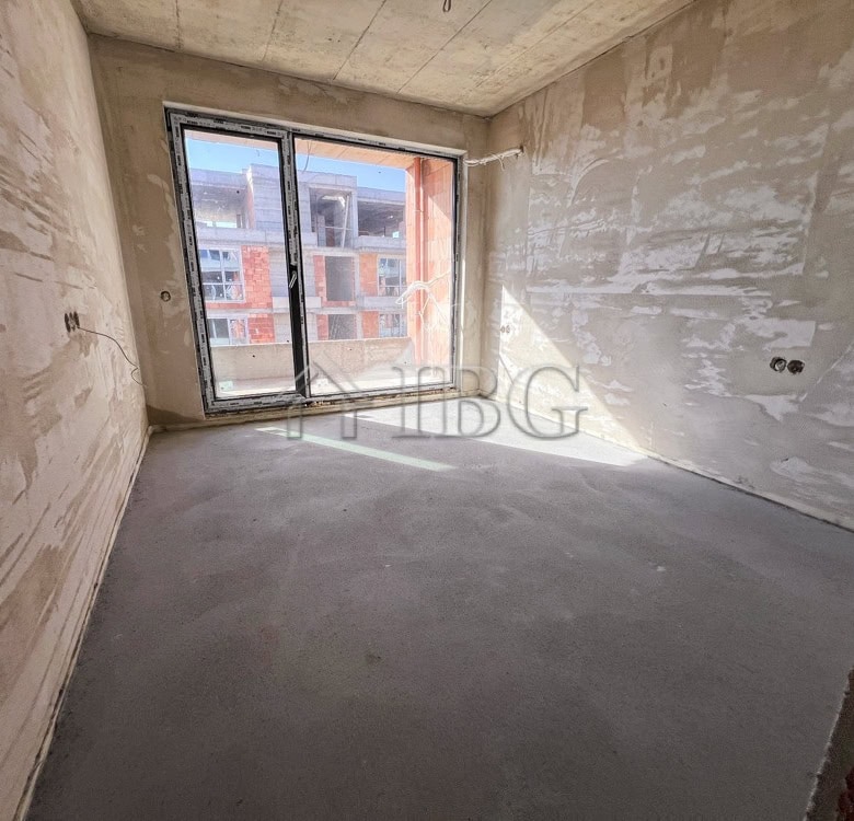 Bright interior with large window in new residential building.