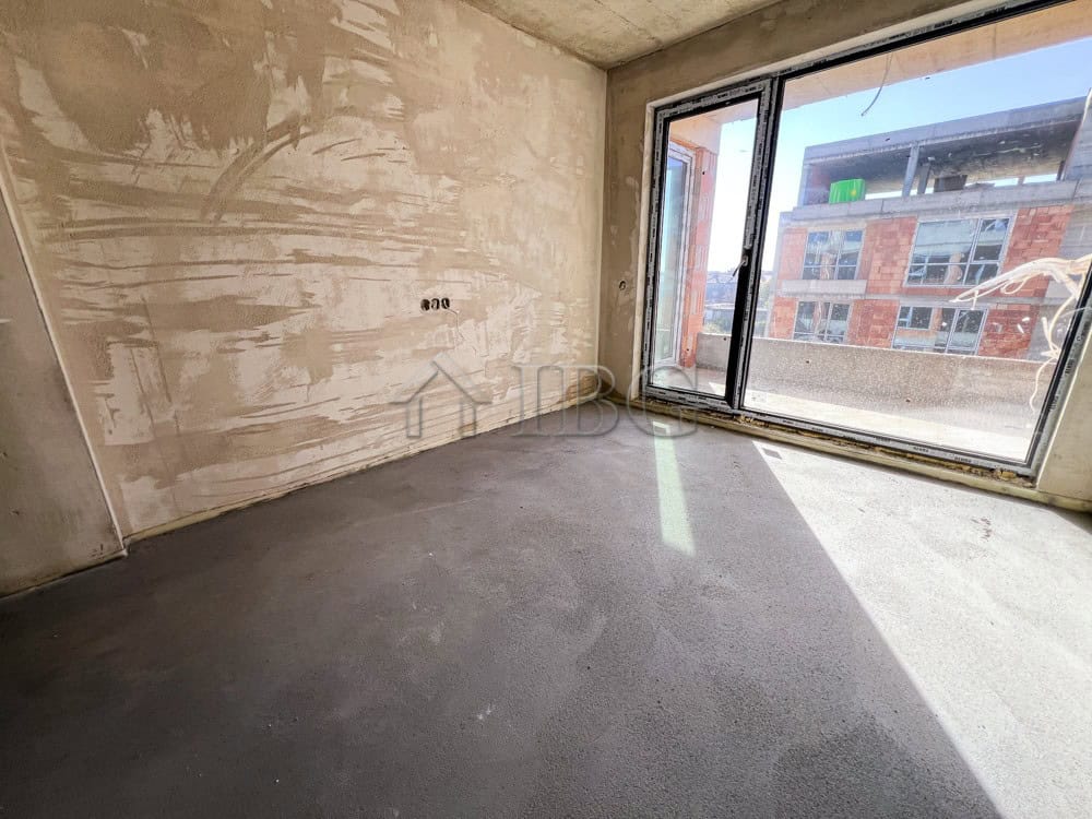 Bright empty room with large windows in a new residential building in Pomorie.