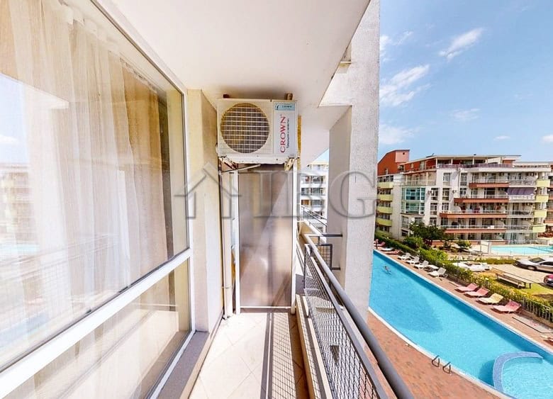 Balcony view of the pool and cityscape from a 1-bedroom apartment in Sunset Beach 2, Sunny Beach.