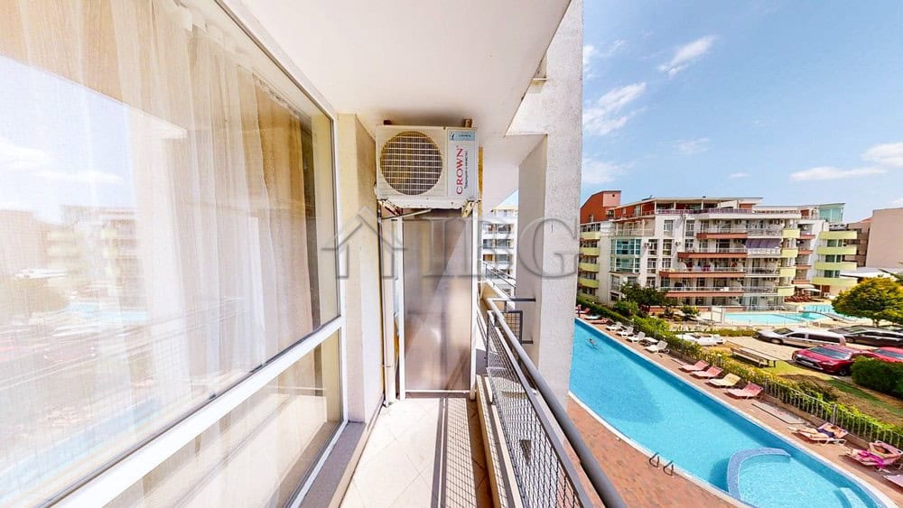 Balcony view of the pool and cityscape from a 1-bedroom apartment in Sunset Beach 2, Sunny Beach.