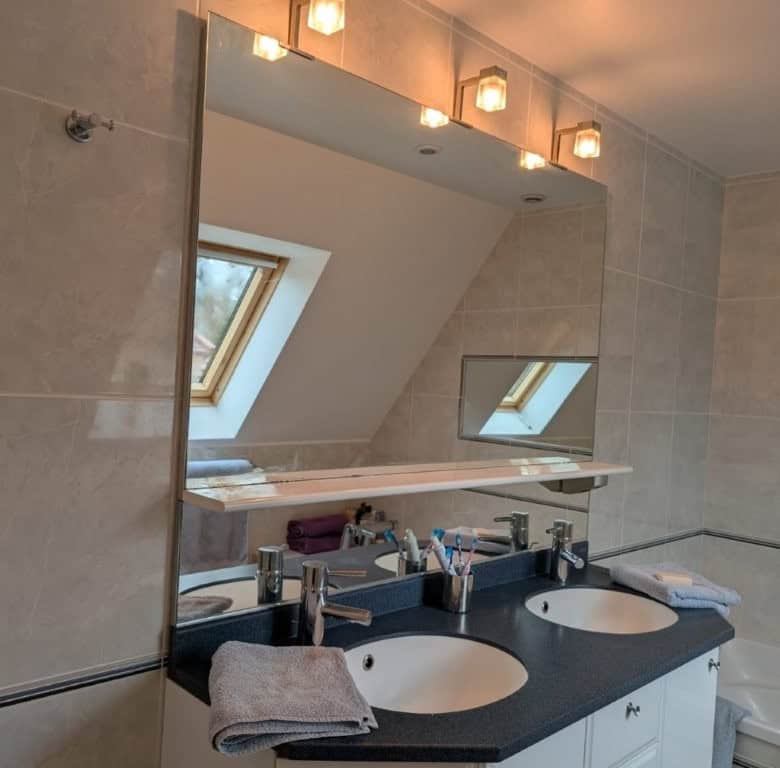 Elegant bathroom with dual sinks and skylight in Dordogne Valley property.