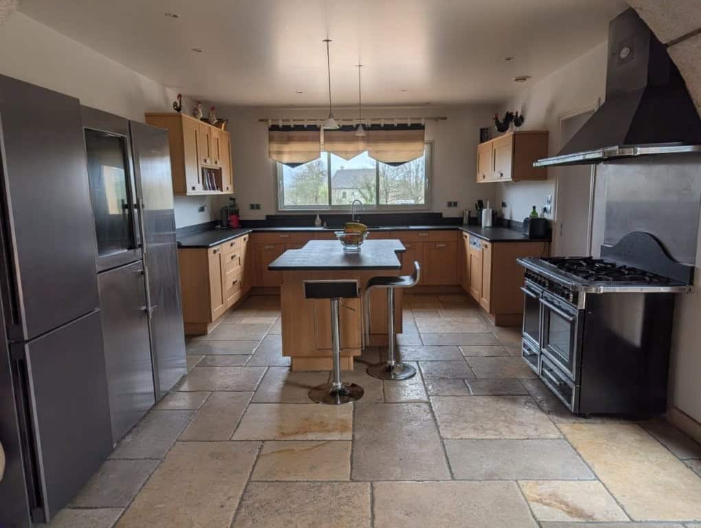 Luxury 4 Bed Le Manoir House Elegant kitchen with modern appliances and spacious layout.
