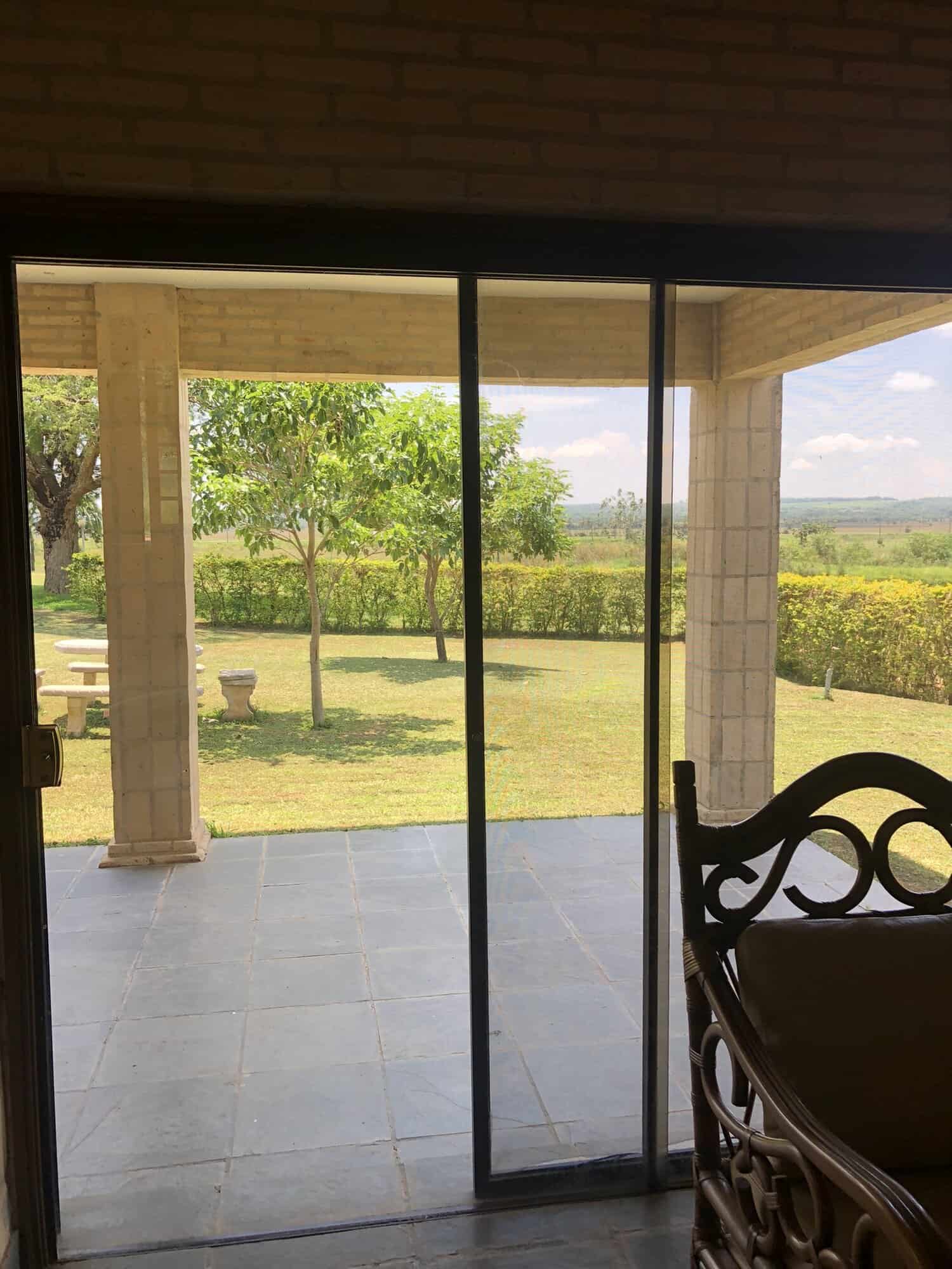 Elegant patio view of lush green landscape at Carlos Franco Golf and Country Club. Outdoor patio with scenic garden and golf course views in Paraguay.