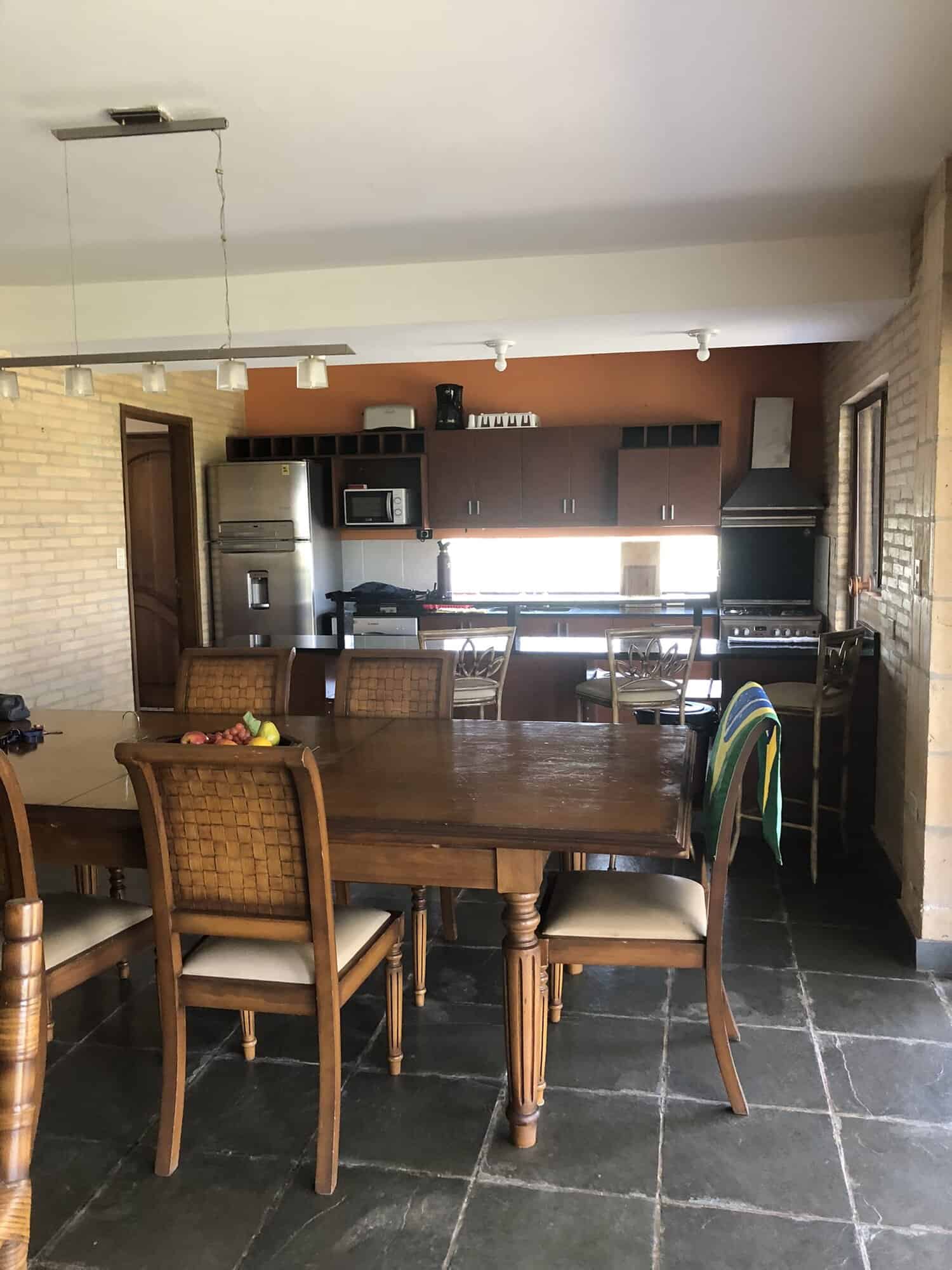 Cozy Kitchen and Dining Area in Paraguayan Home Spacious kitchen with modern appliances and a wooden dining table in a warm, inviting home setting.