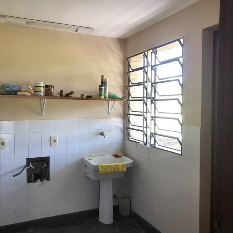 Interior view of a laundry space with a utility sink and window ventilation in Arroyos Y Esteros, Pa.
