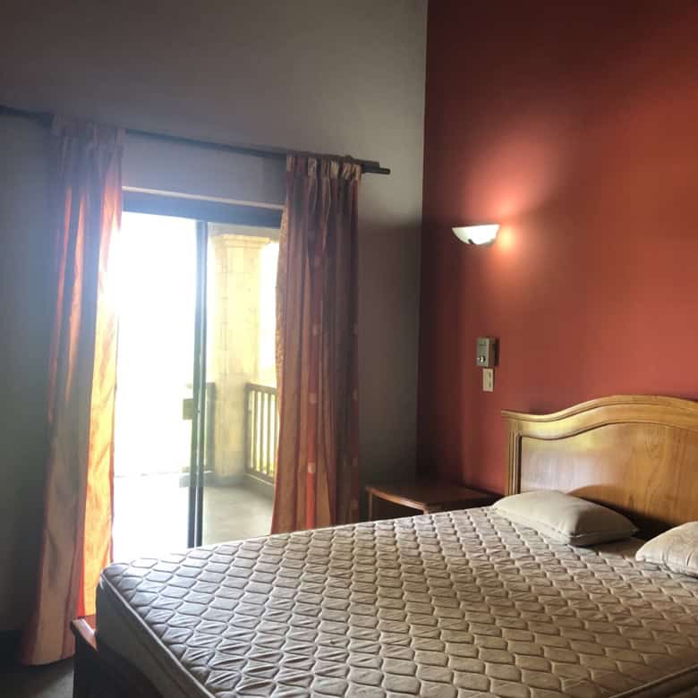 Comfortable bedroom with a balcony overlooking lush surroundings in Carlos Franco Golf and Country C.