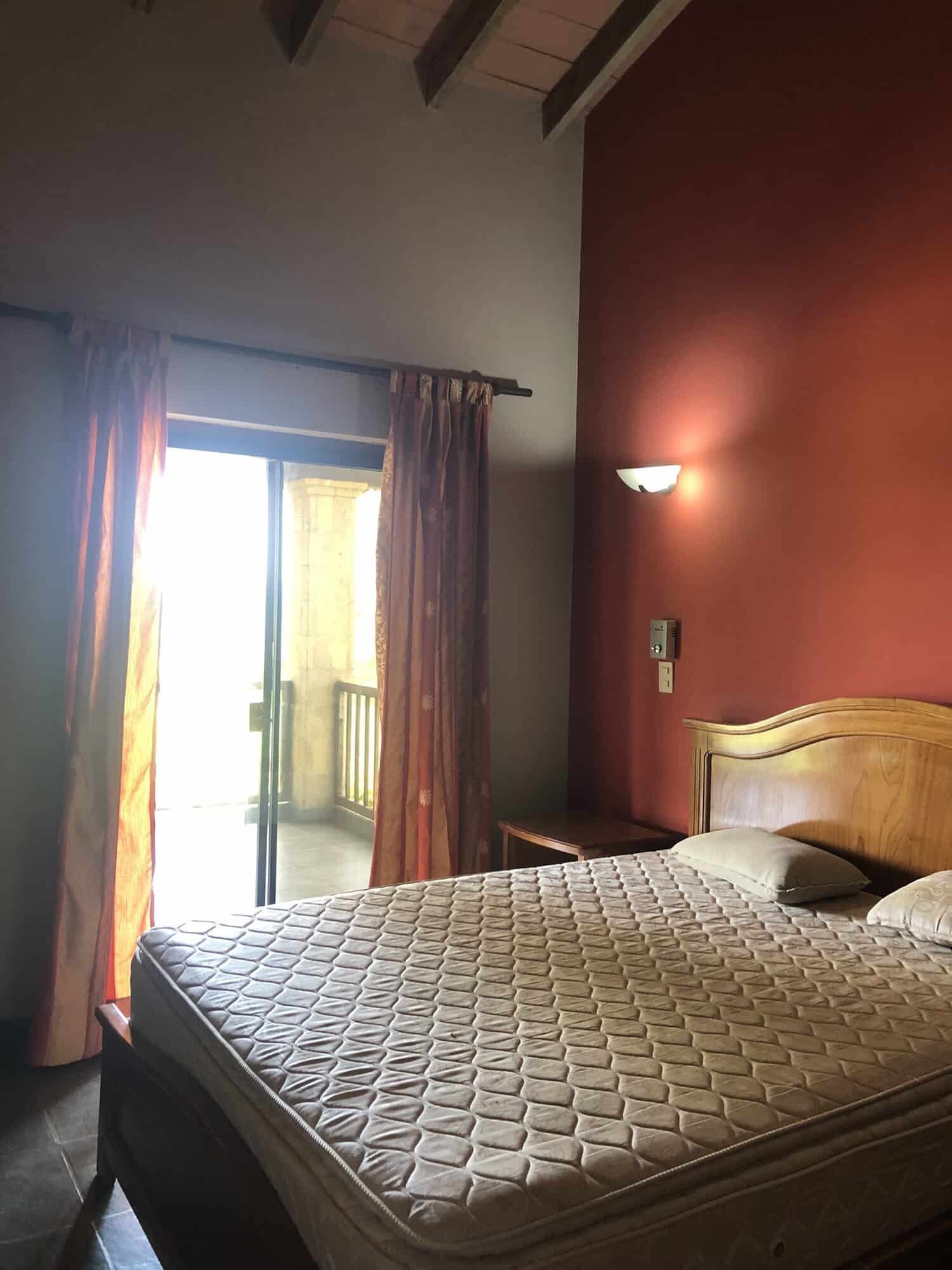 Cozy Bedroom with Balcony View Comfortable bedroom with a balcony overlooking lush surroundings in Carlos Franco Golf and Country C.