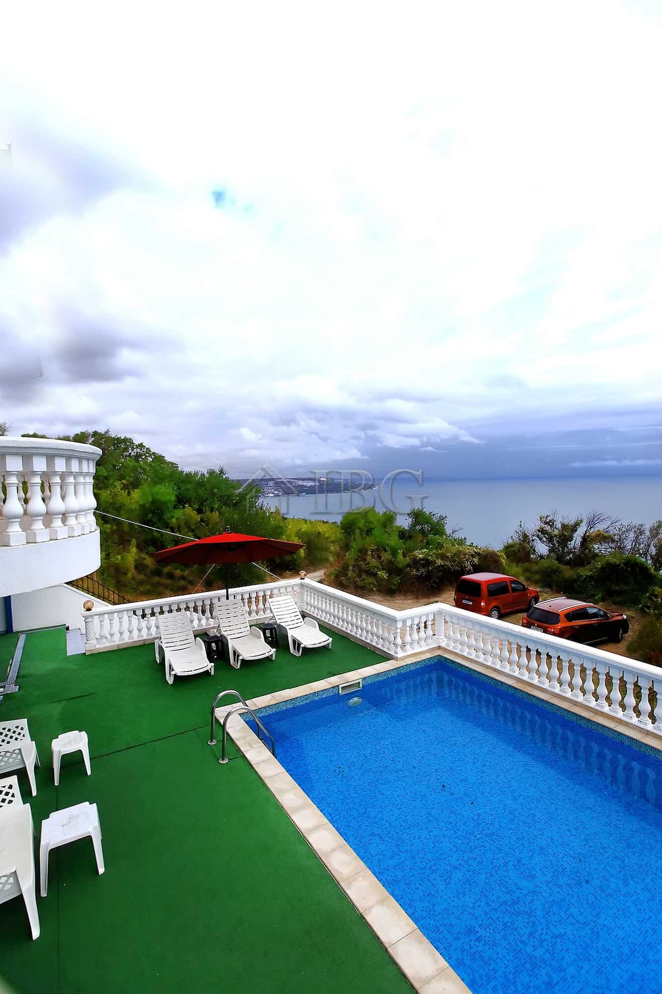Sea view villa with private pool, outdoor lounging area, and scenic coastal surroundings.