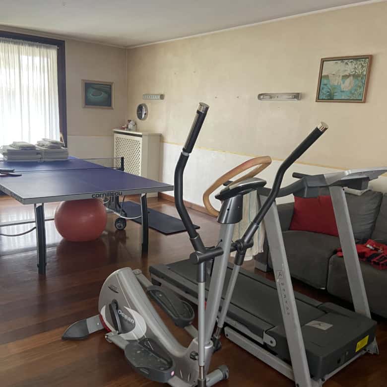 Home gym setup with treadmill and exercise bike in a cozy living room.