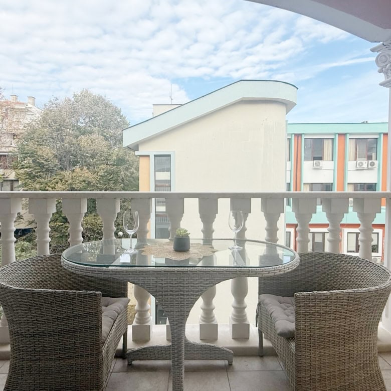 Balcony of a studio apartment in Valencia Gardens, Nessebar, showcasing outdoor seating and scenic s.