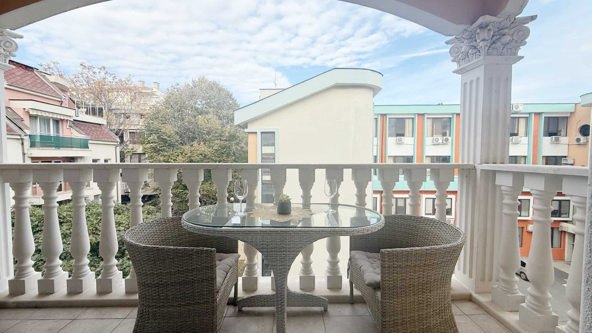 Balcony of a studio apartment in Valencia Gardens, Nessebar, showcasing outdoor seating and scenic s.