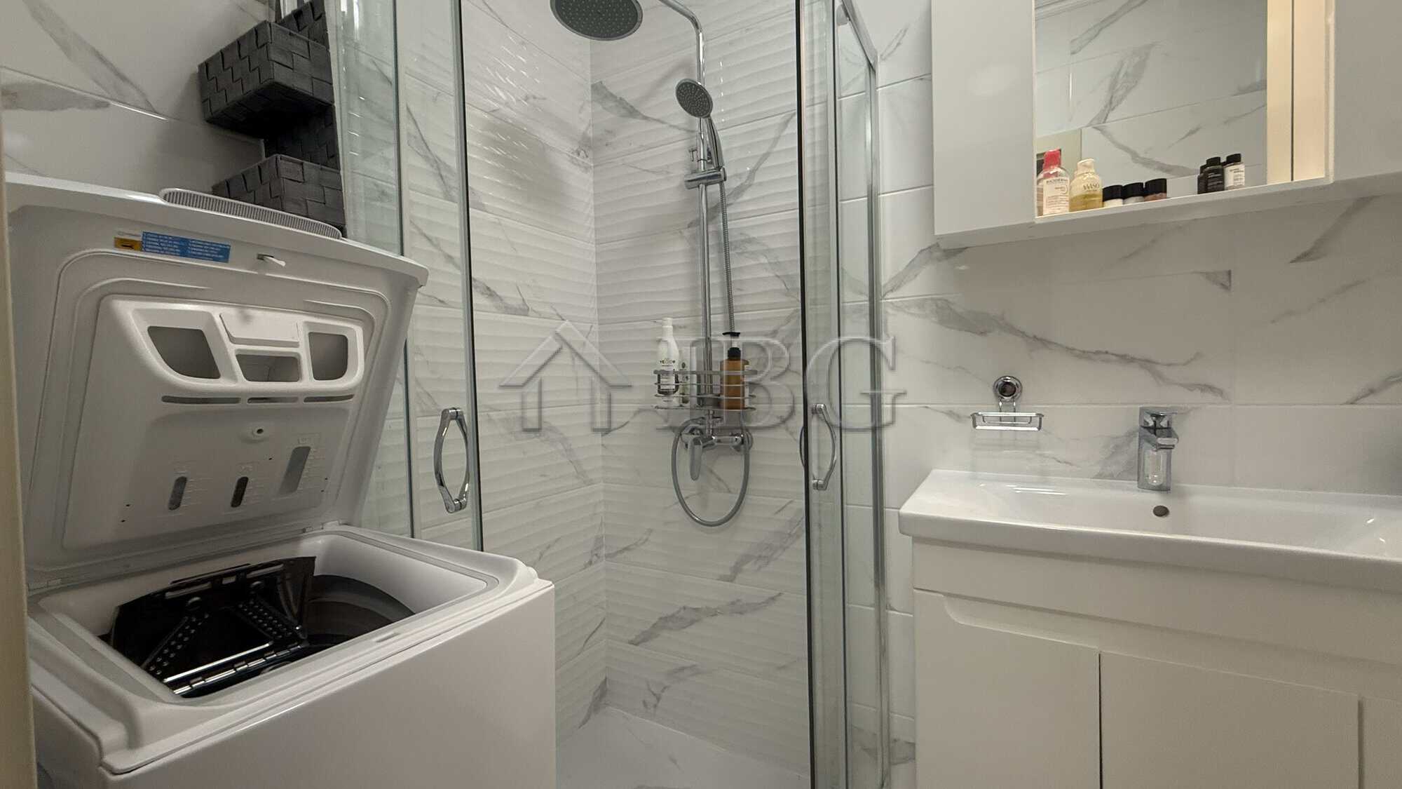 Bathroom of a studio apartment in Valencia Gardens, Nessebar, featuring modern fixtures and marble-s.