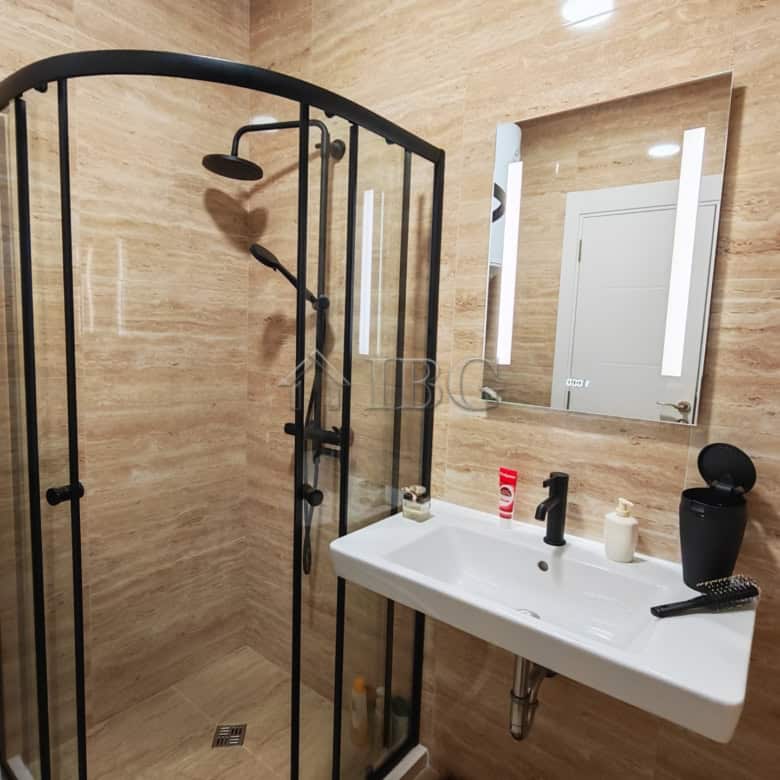 Bright bathroom with shower enclosure and contemporary fixtures in Emilia Romana Boutique Complex.