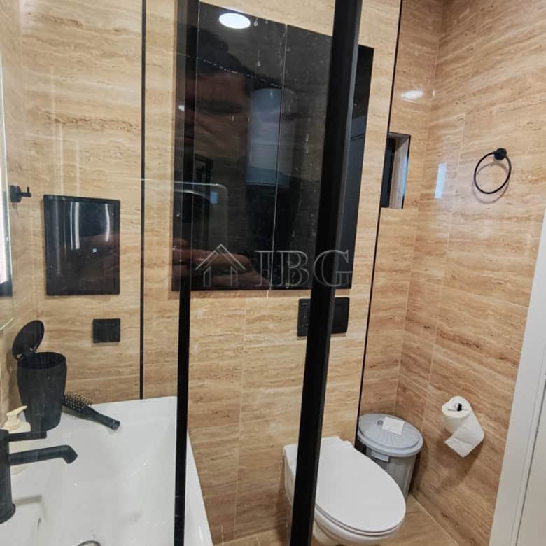 Bathroom with walk-in shower, toilet, and contemporary fixtures in Emilia Romana Boutique Complex.
