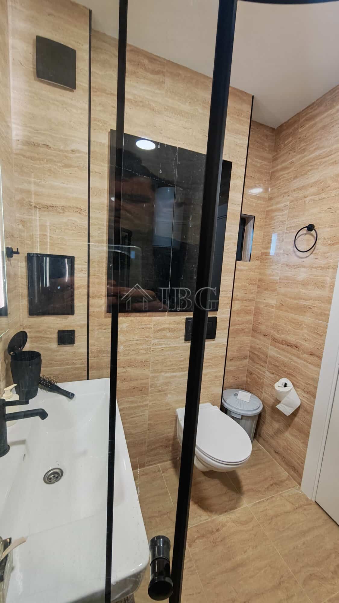 Bathroom with walk-in shower, toilet, and contemporary fixtures in Emilia Romana Boutique Complex.
