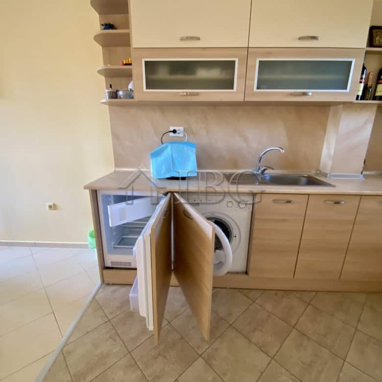 Cozy kitchen with open cabinets and modern appliances in Chateau Del Mar, Sunny Beach.