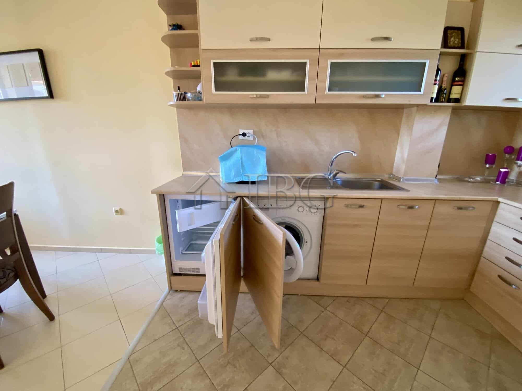 Cozy kitchen with open cabinets and modern appliances in Chateau Del Mar, Sunny Beach.