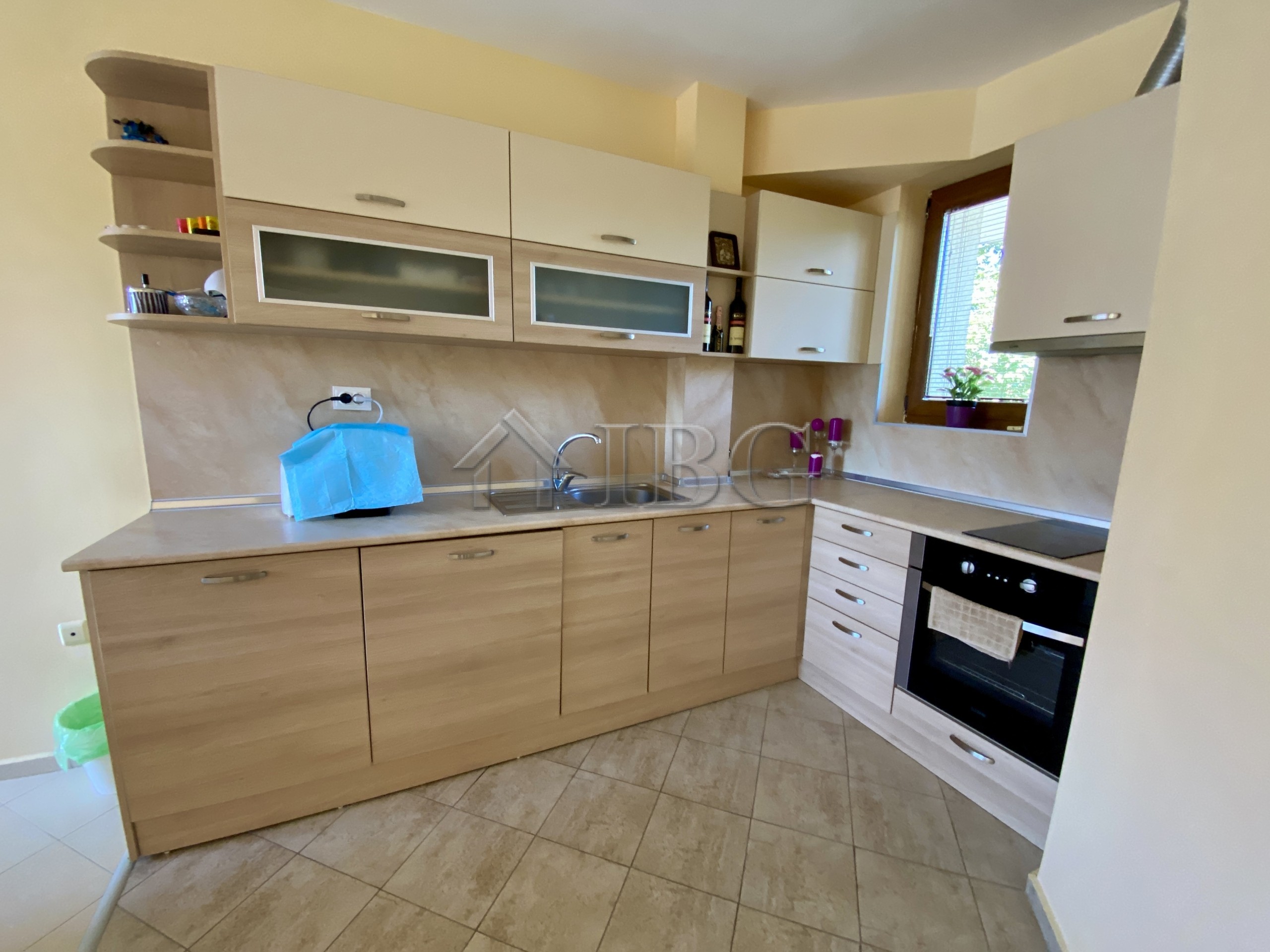 Bright and spacious one-bedroom apartment kitchen with pool view in Chateau Del Mar, Sunny Beach.