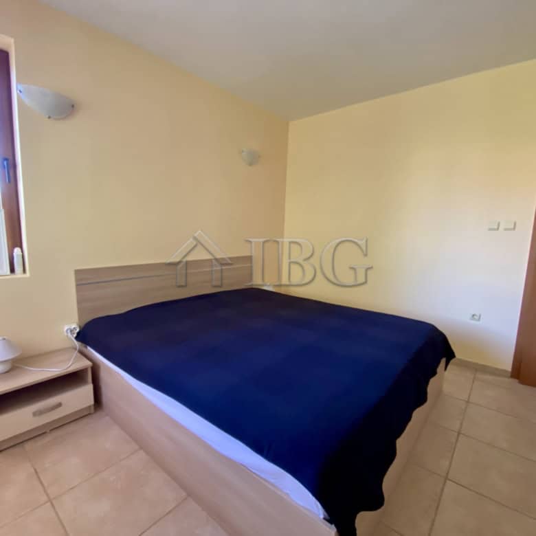 Cozy bedroom with a large window overlooking the pool area in Chateau Del Mar, Sunny Beach.