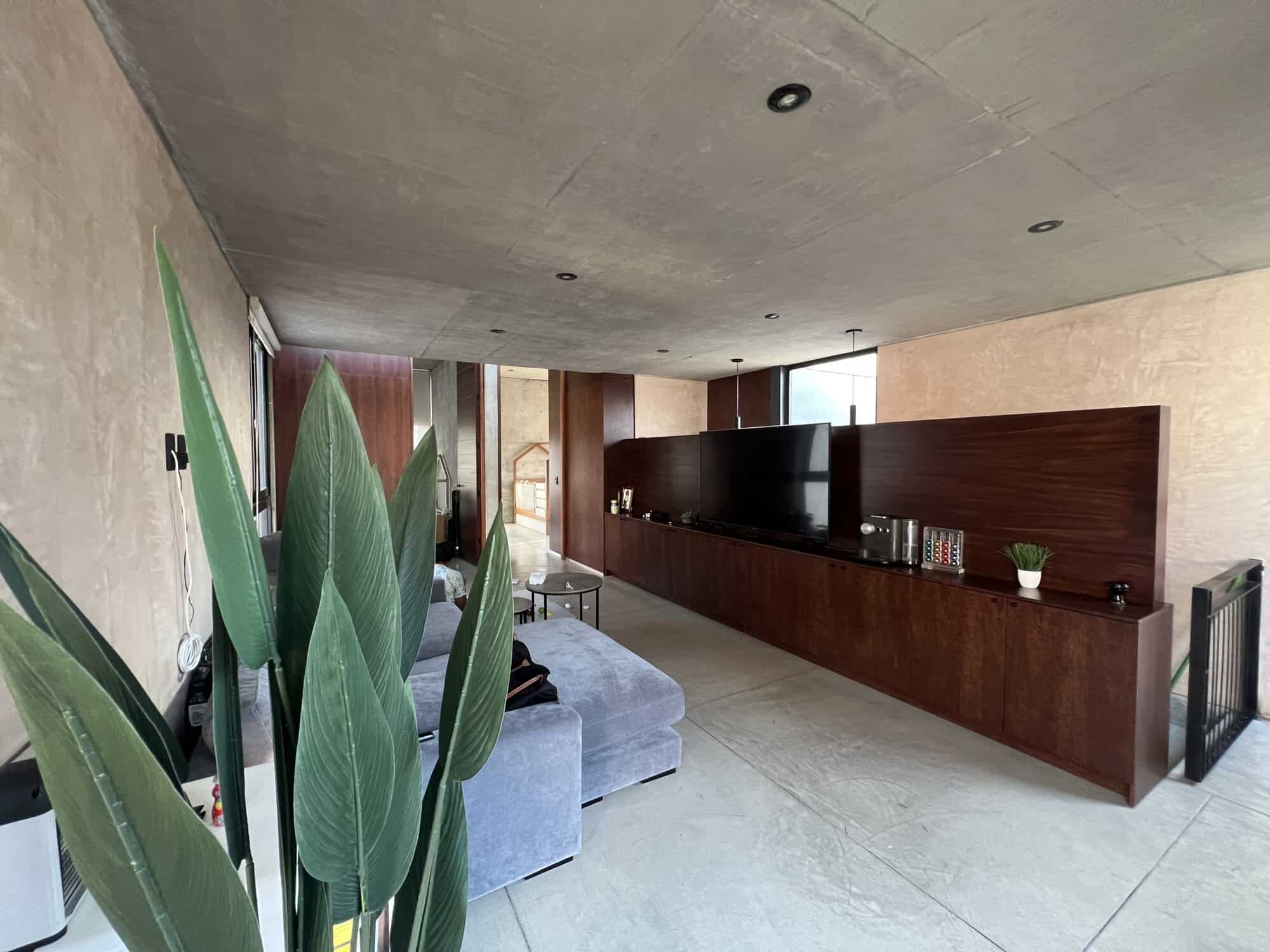 Modern living room with minimalist decor and large windows.