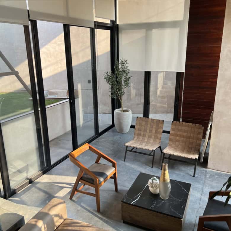 Indoor lounge area with large glass windows and stylish furniture.