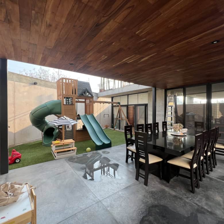 Outdoor patio with play area and dining space for family gatherings.