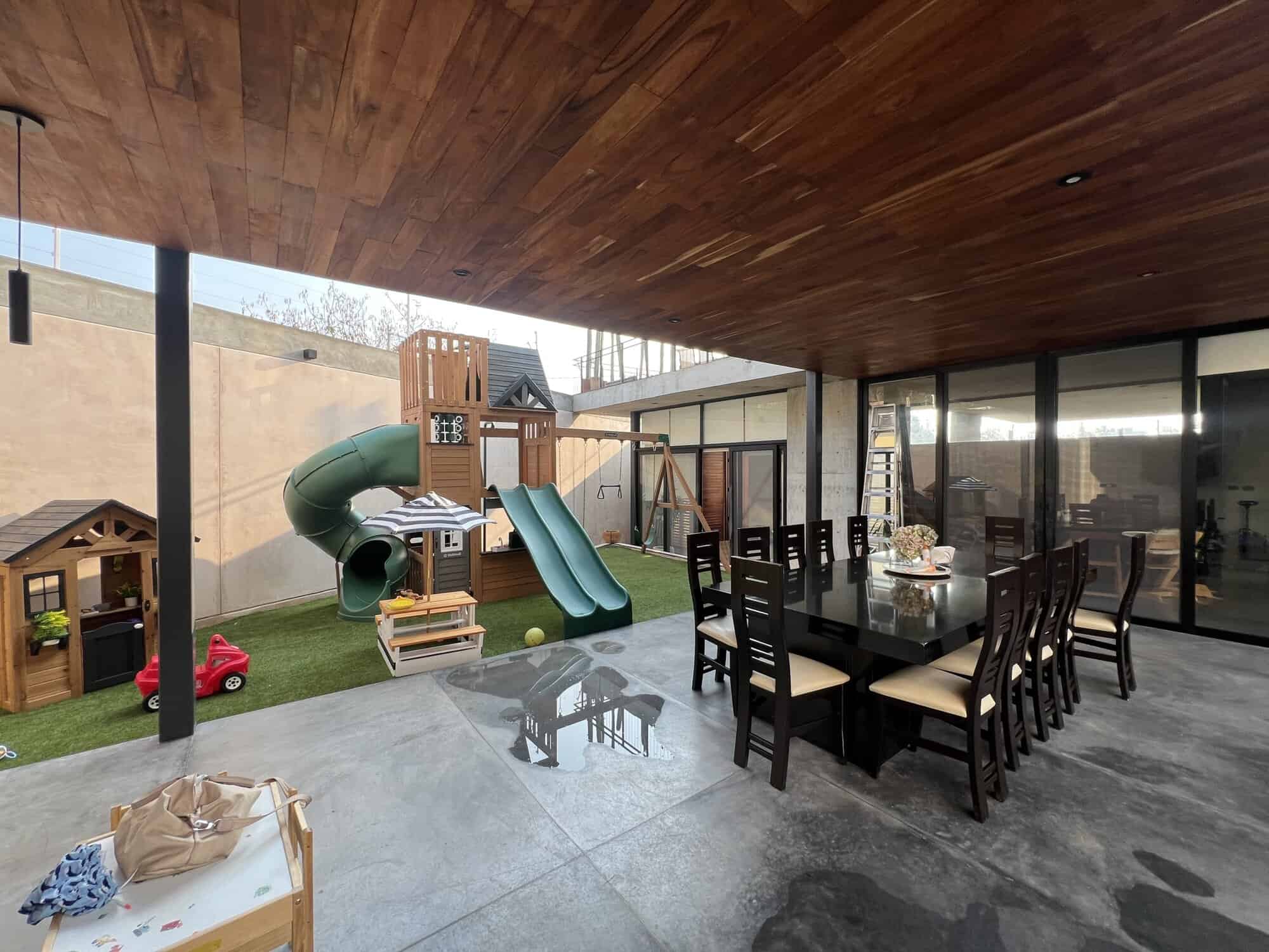 Outdoor patio with play area and dining space for family gatherings.