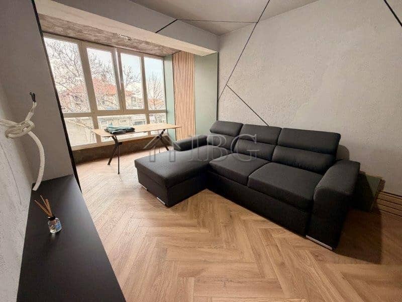 Spacious living room with large windows and contemporary furniture in Ravda residential building.