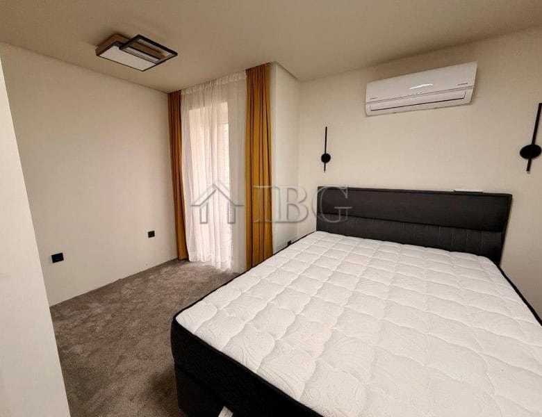 Bright bedroom in Ravda apartment with air conditioning and natural light.