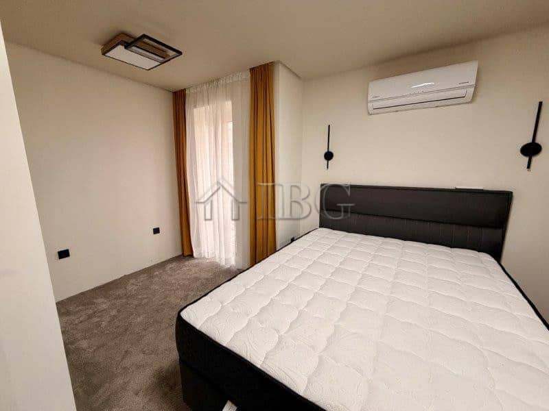 Bright bedroom in Ravda apartment with air conditioning and natural light.