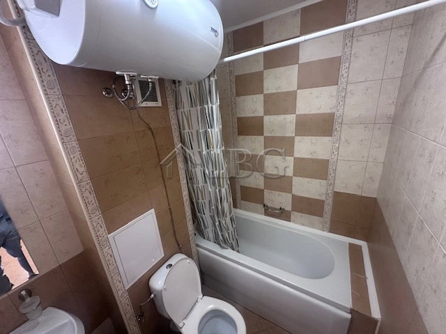 Bright bathroom with bathtub and modern tiles in Royal Sun, Sunny Beach.