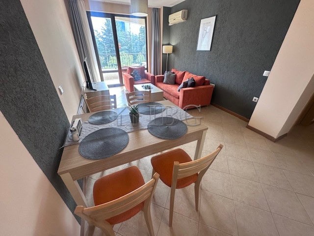 Furnished one-bedroom apartment with living area, balcony, and modern decor in Sunny Beach.