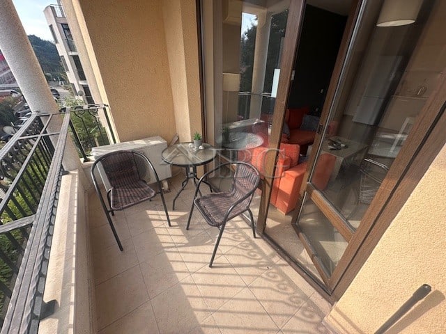 Balcony with outdoor table and chairs in furnished one-bedroom apartment at Royal Sun, Sunny Beach.