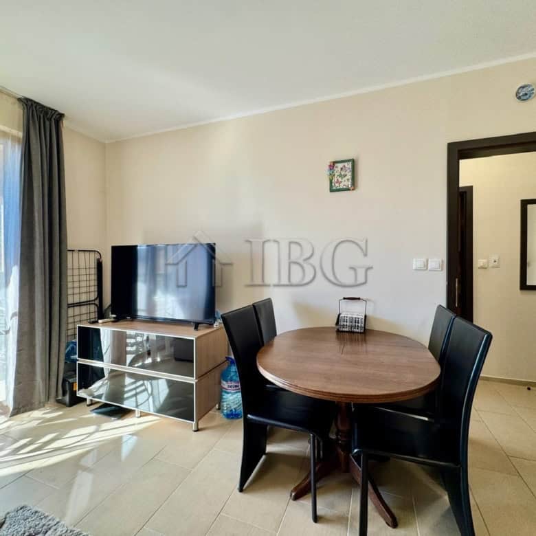 Interior of a 1-bedroom apartment with pool view, dining area, and modern furnishings.