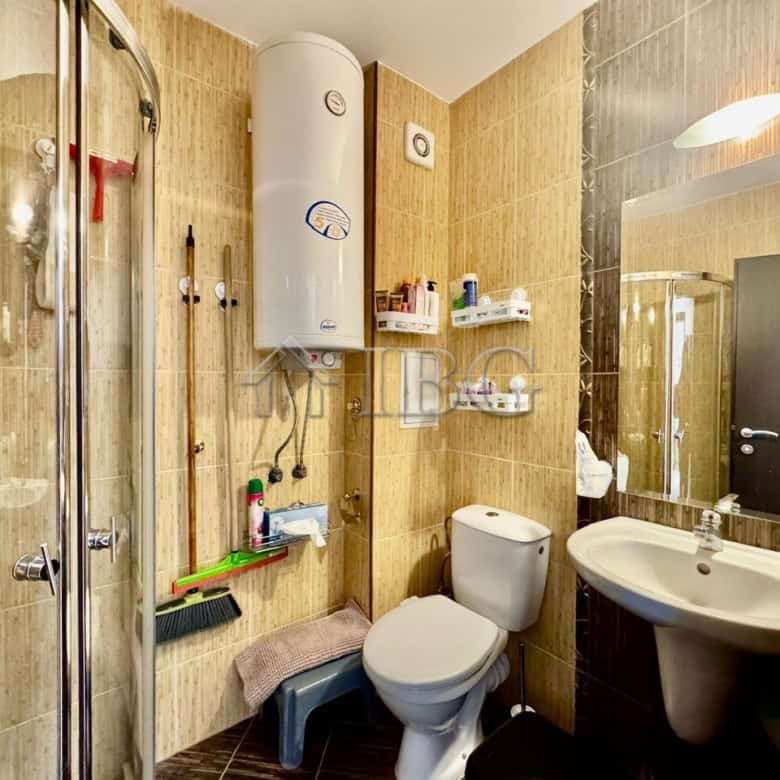 Modern bathroom with shower, toilet, and sink in Harmony Suites 1.