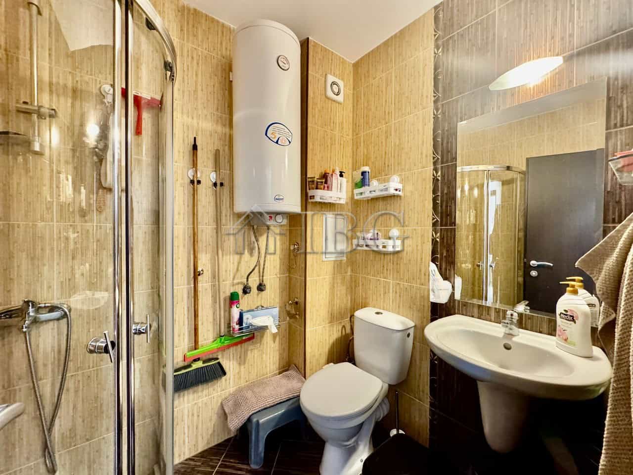 Cozy Bathroom in Sunny Beach Apartment Modern bathroom with shower, toilet, and sink in Harmony Suites 1.