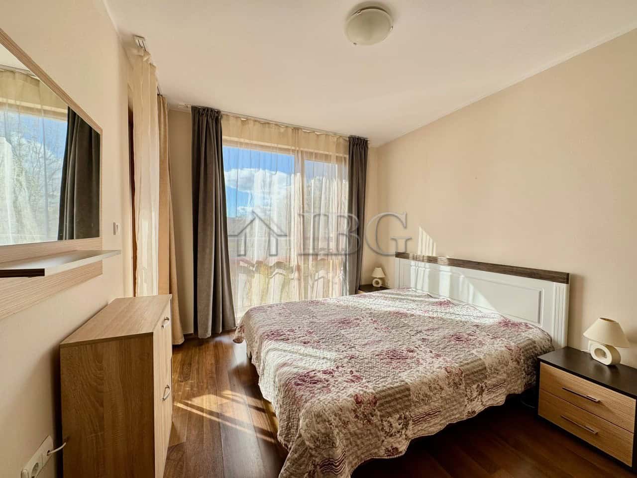 Cozy 1-Bedroom Apartment with Pool View Bright bedroom with large window overlooking pool in Harmony Suites 1, Sunny Beach.