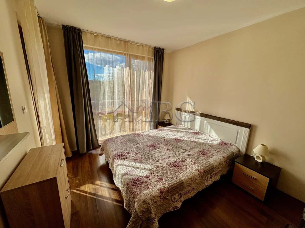 Cozy 1-Bedroom Apartment with Pool View Spacious bedroom with large window overlooking the pool at Harmony Suites 1, Sunny Beach.