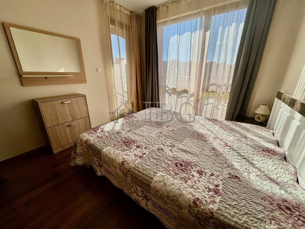 Cozy bedroom with pool view in Sunny Beach Bedroom with large windows overlooking the pool in Harmony Suites 1, Sunny Beach.
