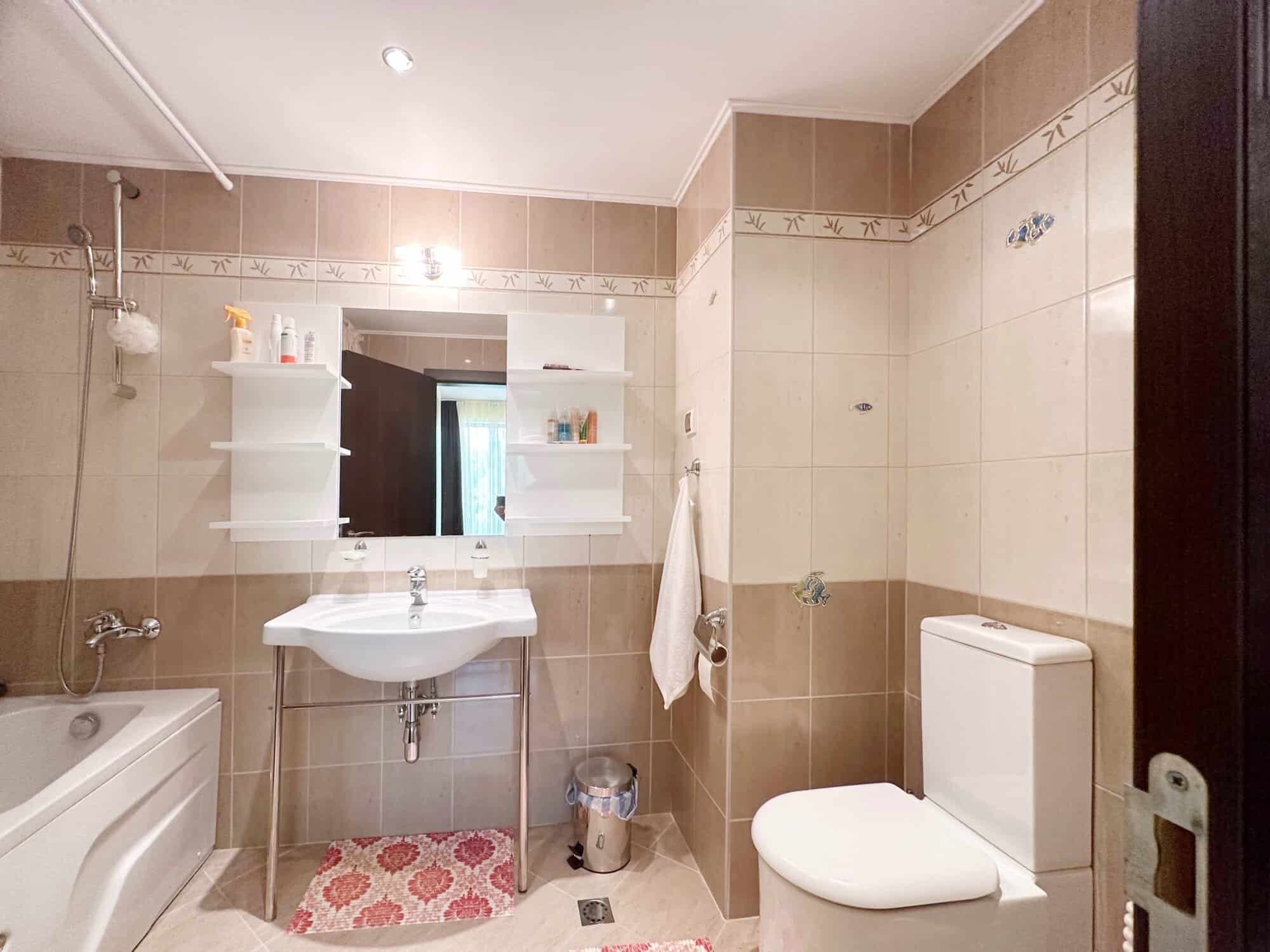 Bright bathroom with bathtub, sink, and toilet in Peter House Complex, Sunny Beach.