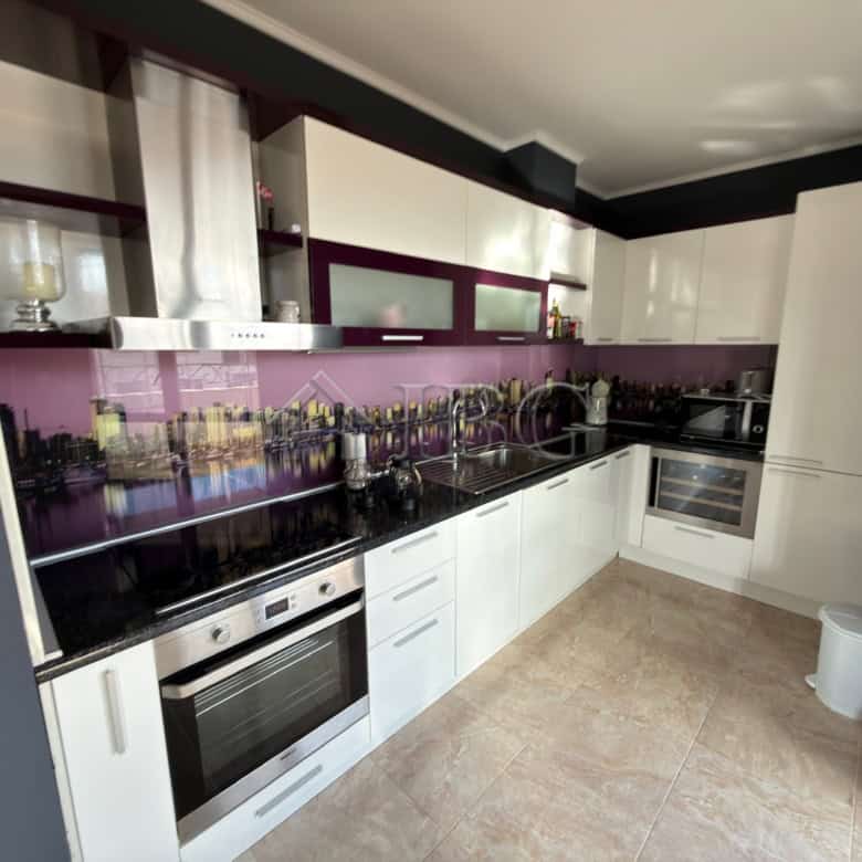Modern kitchen with sleek white cabinets and black countertops in Esteban SPA Complex, Nessebar.