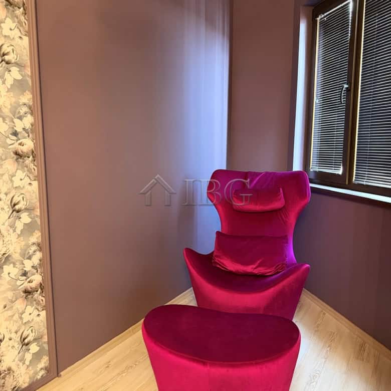 Elegant pink armchair in a modern apartment interior.