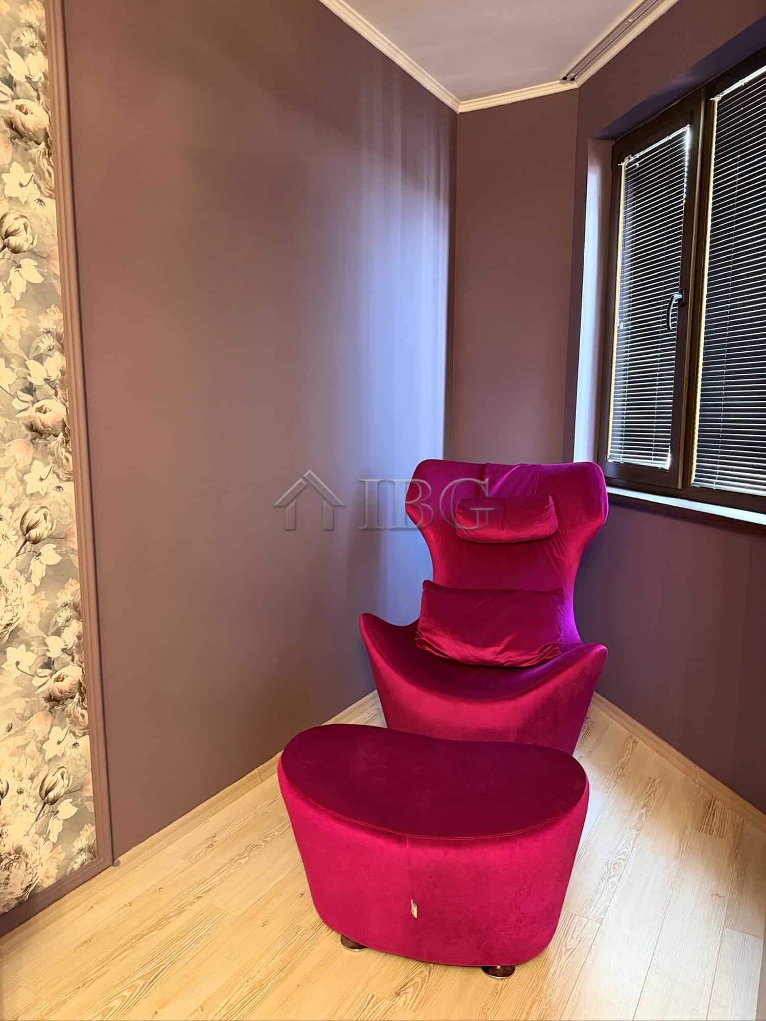 Elegant pink armchair in a modern apartment interior.