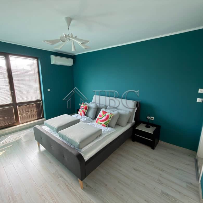 Modern bedroom with a double bed and colorful pillows in Esteban SPA Complex, Nessebar.