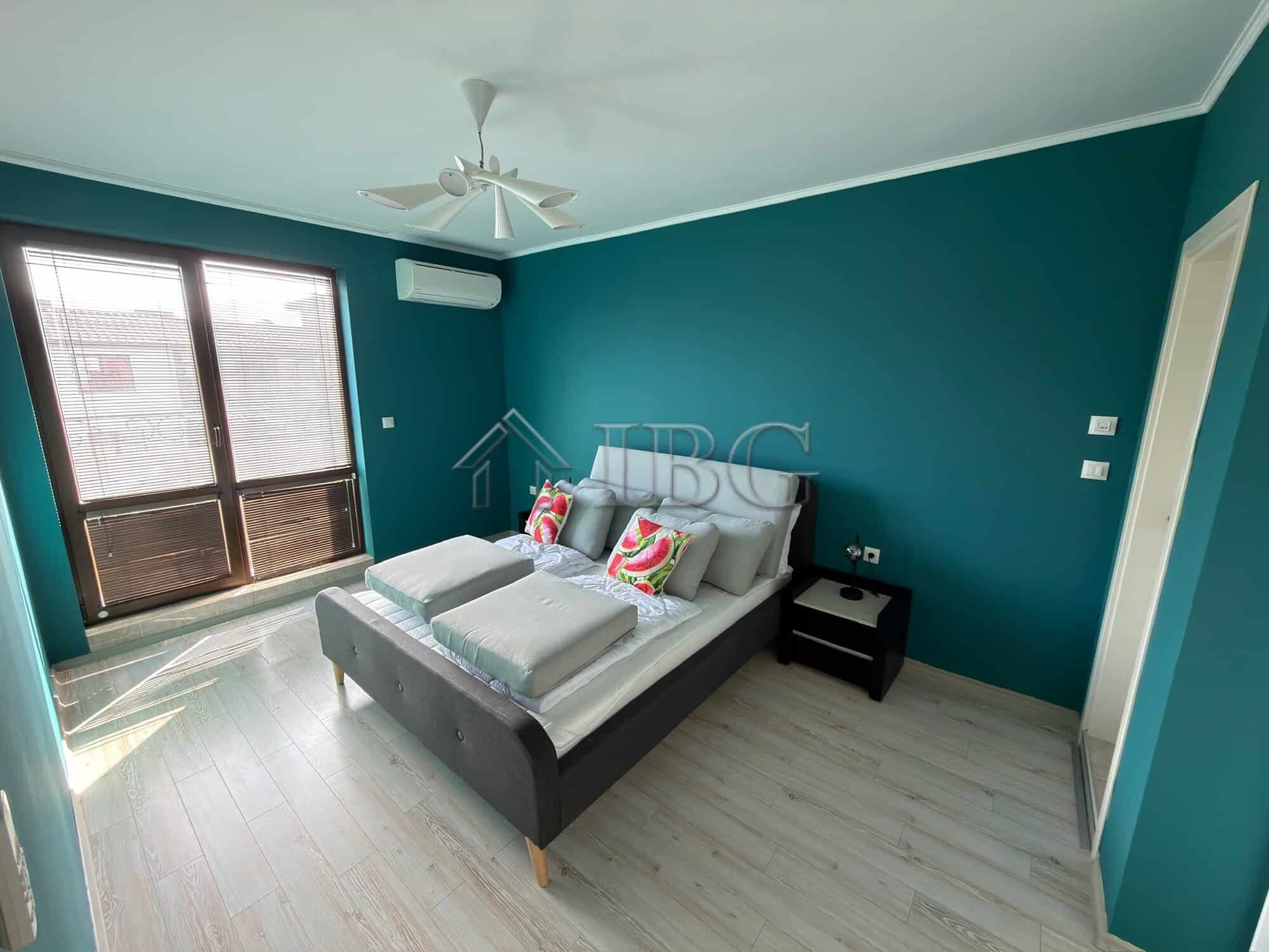 Modern bedroom with a double bed and colorful pillows in Esteban SPA Complex, Nessebar.