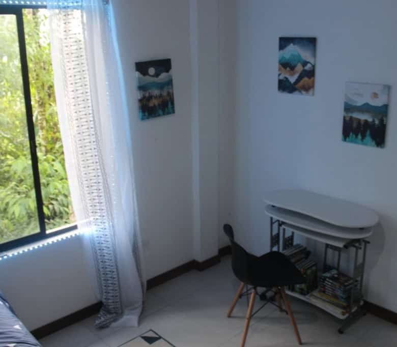 Spacious interior of a 5-bedroom house in Portal de Mindo, Ecuador, featuring bright natural light a.