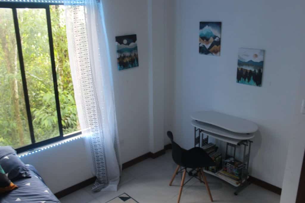 Spacious interior of a 5-bedroom house in Portal de Mindo, Ecuador, featuring bright natural light a.
