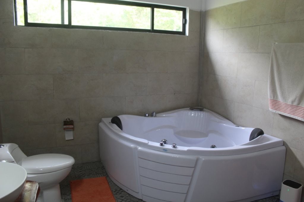 Bathroom with whirlpool tub and modern fixtures in Ecuador property.